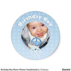 a blue birthday card with an image of a baby in the center and snowflakes around it