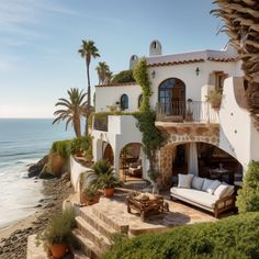 a house on the beach with palm trees