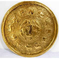 an ornate gold plate with animals on it