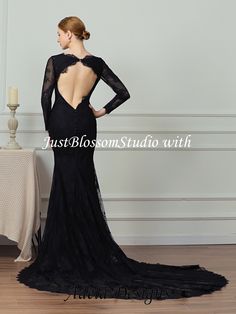 a woman in a black dress with an open back