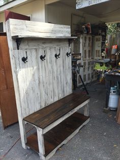 a bench made out of an old door and some hooks on the back of it