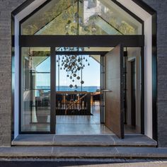 An exterior shot of a bespoke entrance area with glass front door and corten steel Large Modern House, Front Door Entrance, Glass Front Door, Front Entrances, Sash Windows