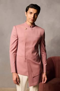 Pink asymmetric hem bandhgala with placement pleats. - Aza Fashions Fitted Nehru Jacket With Traditional Drape For Groom, Designer Stand Collar Bandhgala For Wedding, Designer Tailored Bandhgala For Wedding, Designer Bandhgala With Stand Collar For Wedding, Designer Fitted Kurta For Groom, Fitted Bandhgala With Stand Collar For Wedding, Tailored Nehru Jacket With Stand Collar For Wedding, Semi-formal Fitted Kurta With Stand Collar, Designer Fitted Bandhgala With Stand Collar