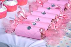 a table with pink and white cupcakes on it