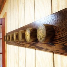 wooden pegs are arranged on the side of a wall