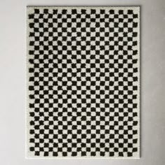 a black and white checkerboard pattern on a wall