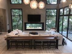 a living room with large windows and white couches