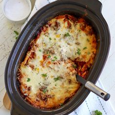 a close up of a casserole dish with meat and cheese in it on a table