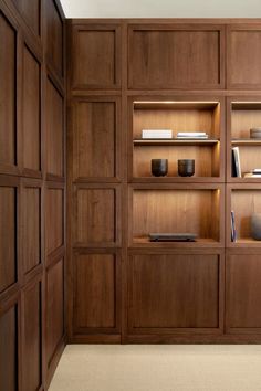 a wooden shelf filled with books and vases