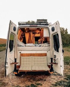 an rv is parked on the side of the road with it's doors open