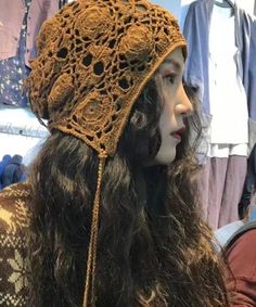 a close up of a person wearing a hat with crocheted lace on it