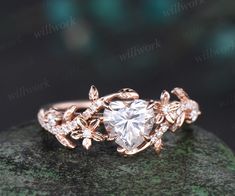 a rose cut diamond ring on top of a rock