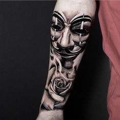 a guy with a mask and roses on his arm