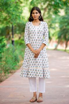 "If you are looking forward to exuding regality, check out this hand block print premium cotton A-line set. This piece is crafted with vibrence, and the design is uplifted with delicate hand block print designs laced up in the center is a perfect look for a summer day. Detail: This is 2 Pc. Set Kurta set : Cotton hand block printed kurta set  Color : White, teal & brown (Kurta).  White (Pants) Composition : 100%  Cotton (Premium quality) Length : 43 Inches (Kurta).  35 Inches (Pants) Wash care :  Hand wash separately in cold water. Do not soak and scrub. Dry in shade Model Size - Model (5'9\") is wearing size S" Block Printed Kurta, Kurta Set For Women, Brown Hand, Hand Block Print, Kurta Set, White Pants, Ethnic Wear, Set For Women, Block Print