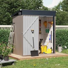 a garden shed with its doors open and tools in the storage area next to it