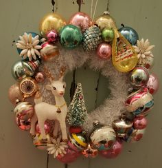 a christmas wreath with ornaments hanging from it