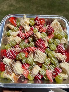 a metal tray filled with fruit covered in white icing