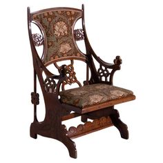 an ornate wooden chair with a floral upholstered seat