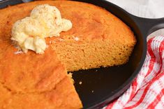 a skillet with a piece of cake in it next to a red and white towel