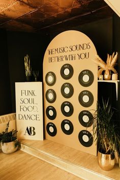 there are many records on the wall next to each other in front of a plant