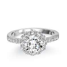 a diamond engagement ring with an halo setting and pave set diamonds around the band