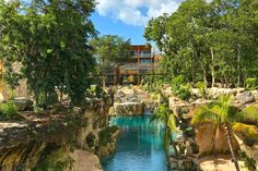 an outdoor swimming pool surrounded by trees and rocks