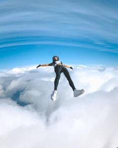 a man flying through the air while riding a snowboard on top of some clouds