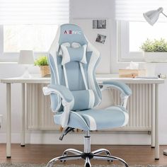 a blue and white office chair sitting in front of a desk