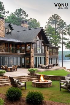 An elegant lakeside home with a spacious outdoor patio, cozy fire pit, and beautiful views of the lake, perfect for relaxing or entertaining. Colorado Lake House, Stone Lake House, Lake House Inspiration, French Lake House, Luxury Cabin Homes, Lakehouse Backyard, Lake Home Interior, Lake House Architecture, Lake View Homes