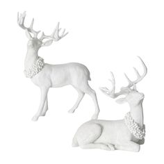 two white deer figurines sitting next to each other