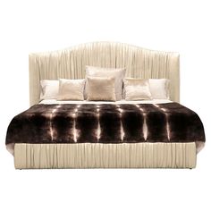 the bed is made up with pillows and blankets on it's headboard, along with two throw pillows