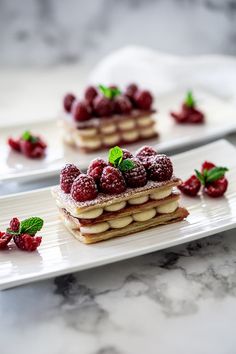 raspberry shortbreads with powdered sugar and mint on white plates, ready to be eaten