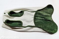 a pair of green shoes sitting on top of a white cloth covered in velcam