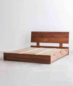 a wooden bed frame with two drawers on each side and no headboard or foot board