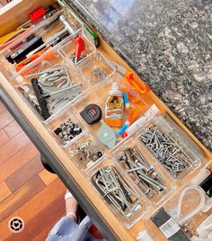 the drawer is filled with assorted tools and other things to make it easier for someone to use