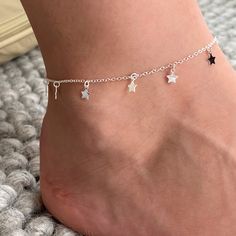 A beautiful sterling silver ankle bracelet with little star charms. This contemporary sterling silver ankle bracelet would make a great gift for any occasion. The piece is finished with an extension chain enabling the ankle bracelet to be adjusted to your perfect fit. It is simple, on trend and easy to wear day or night. The ankle bracelet would make a great gift for a friend or loved one as a thank you, or token gift Each ankle bracelet arrives in a striking white and silver gift box with a fre Dr Accessories, Baby Jewellery, Star Anklet, Silver Ankle Bracelet, Pretty Jewelry Necklaces, Family Rings, Ankle Jewelry, Silver Gift Box, Basic Jewelry