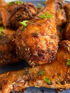 chicken wings with herbs and seasoning on a blue plate