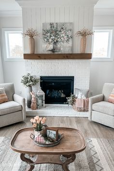 a living room with two couches and a coffee table in front of the fireplace