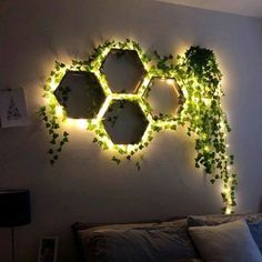 a bedroom with plants growing on the wall and lights in the corner above it, along with a bed