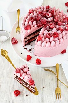 a cake that has been decorated with raspberries