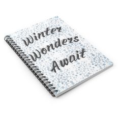 a spiral notebook with the words winter wonders await written in black ink on white paper