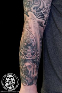 a man with a black and grey tattoo on his arm