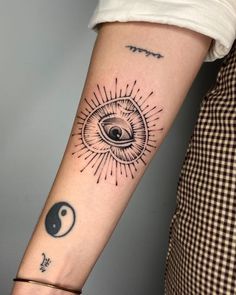 a woman's arm with an all seeing eye tattoo on it