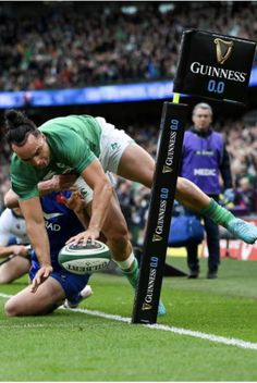 a rugby player dives for the ball during a game