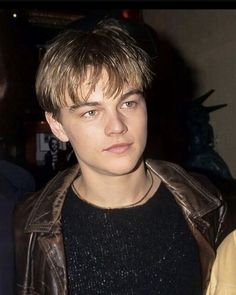 a close up of a person wearing a leather jacket