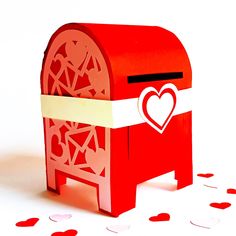 a red mailbox with a heart cut out on the front and side, surrounded by hearts