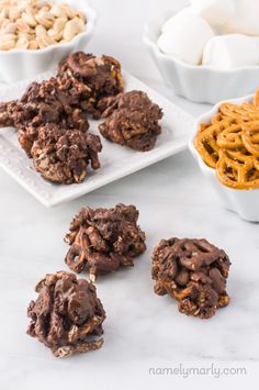 chocolate cookies, pretzels and other snacks are on the counter top next to bowls of cereal