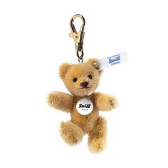 a brown teddy bear with a name tag on it's keychain is shown