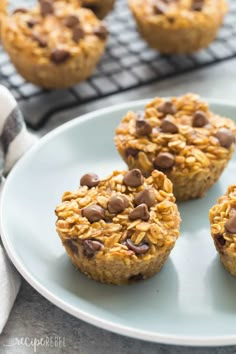 three muffins on a plate with chocolate chips