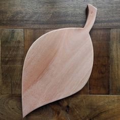 a wooden cutting board sitting on top of a wooden floor